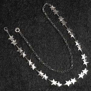 Detail of silver star charm double-layered chain belt with polished metal finish