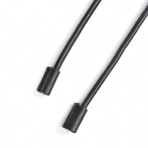 Macro shot of durable black leather cord ends with neat stitching for fashion accessories