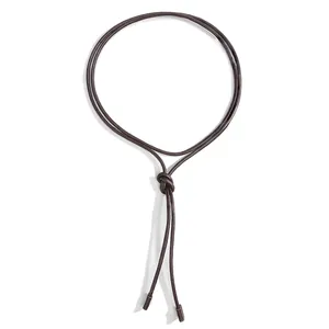 Minimalist knotted dark brown leather waist rope with metallic tips on white background