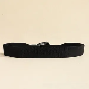 Close-up of the vintage engraved silver buckle and black elastic fabric waist belt