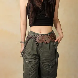 Detail of vintage brown bohemian belt with metal eyelets and decorative buckle