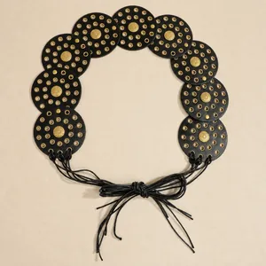 Detail view of Bohemian rivet disc belt with golden sunflower studs and leather tassels