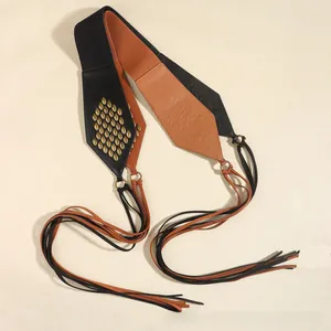 Detail of vintage suede tassel belt with gold studs and contrasting leather panels