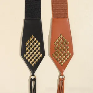 Detail of vintage suede tassel belts with metallic studs in black and brown finishes