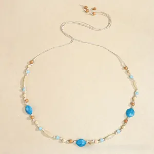 Detail view of Bohemian woven waist rope featuring blue resin beads and ethnic tassels