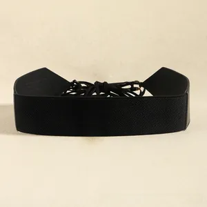 Detail of black elastic corset belt with lace-up back and gold metal ring fasteners