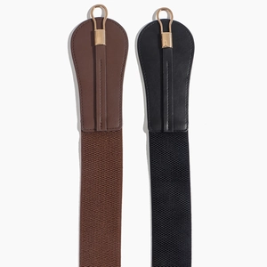 Detail view of high-elasticity woven wide belts with teardrop leather ends and gold metal rings