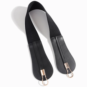 Close-up of black elastic waist belt with gold metal hook buckles and faux leather ends