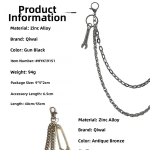 Detail view of punk double layer metal trousers chain with wrench pendant and safety pin