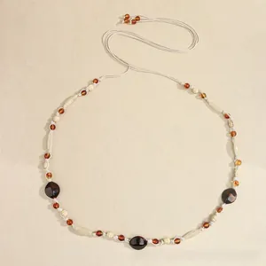 Detail of bohemian braided waist rope with brown beads and resin stones for dresses