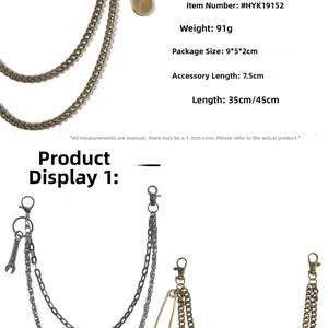 Detail of punk style layered metal pants chains with wrench and paperclip pendants