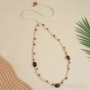 Detail showing Bohemian braided belt with amber beads and dark brown stones