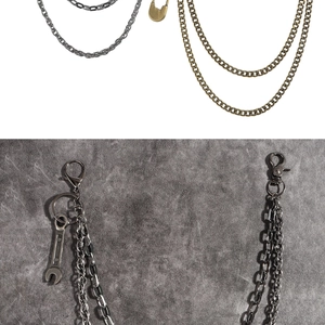 Detail of punk double-layer metal pant chain with safety pin and wrench pendants