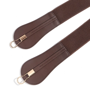 Detailed view of elastic belt ends with dark brown faux leather and gold U-shaped buckles