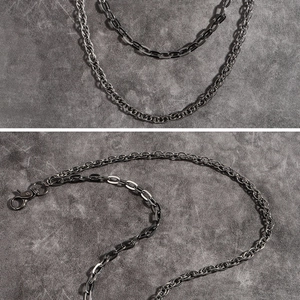 Close-up of dual-layer punk metal chains with lobster clasps in dark gunmetal finish