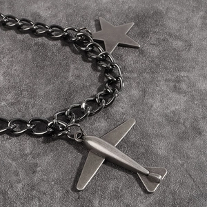 Détail de chaîne punk couleur fusil avec pendentifs en forme d'étoile et d'avion