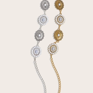 Detail of vintage metal waist chain with sunflower pattern and marble texture inserts