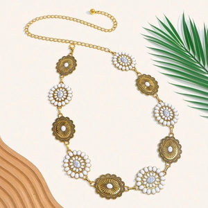 Detailed close-up of boho sun motif metal waist chain with white marble beads