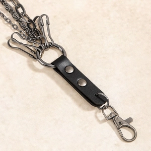 Close-up of vintage punk waist chain featuring metal rivets and high-quality leather connector