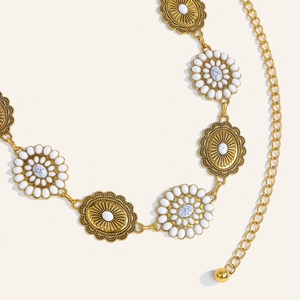 Detailed macro view of vintage gold chain belt with sunflower links and white stones