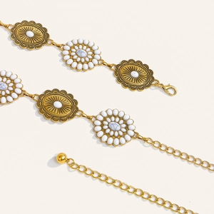 Close-up of bohemian hollow metal waist chain with floral motifs and white marble beads