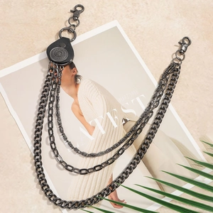 Detail of multi-layer gunmetal chains with black leather connectors and vintage carvings