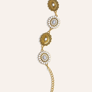 Close-up of bohemian gold chain belt with floral metal carvings and marble stones