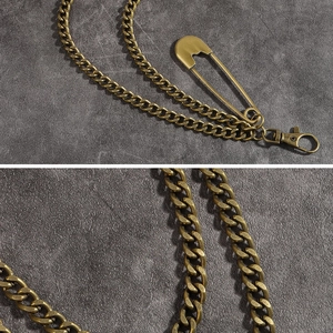 Detail view of vintage bronze double metal chain with safety pin pendant and clasp