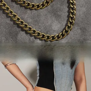 Detailed macro view of vintage bronze double chain with textured metallic finish and link style