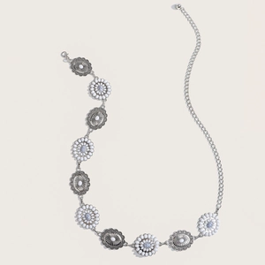 Detail of vintage silver waist chain with floral engravings and colorful stones