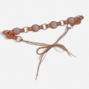 Detail of Bohemian leather belt with turquoise inlay and silver metal rings for dresses
