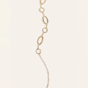 Detail of polished gold metal belt chain with interlocking oval and round links