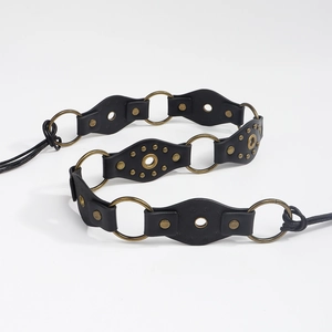 Detail of vintage black leather waist chain with bronze studs and metal rings