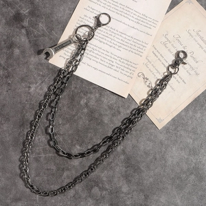 Punk style double layered metal pants chain with wrench pendant on a textured background