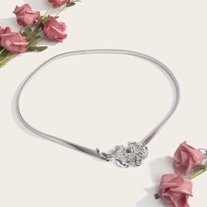Close-up of silver elastic metal waist chain featuring a delicate rose flower buckle