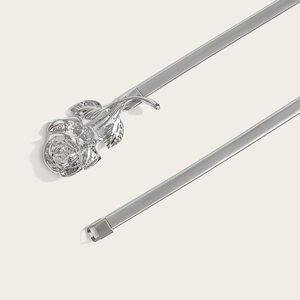Detailed macro shot of a silver metal stretch belt with a 3D rose flower buckle