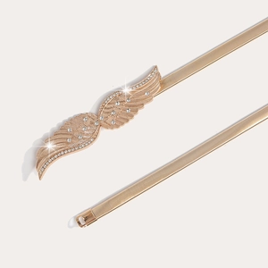 Detail of gold elastic snake chain belt with crystal-encrusted wing buckle design