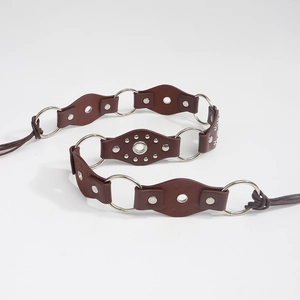 Detail of dark brown leather belt with metal rings, rivets and braided rope ties