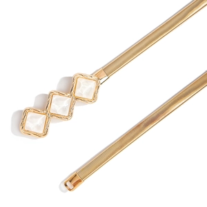 Close-up of golden elastic metal belt featuring triple diamond buckle and white mica inlays