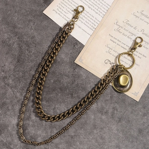 Detail of vintage bronze double-layered pants chain with cowboy hat pendant and lobster clasps
