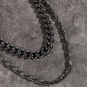 Detail of double-layered punk metal trousers chain with polished dark cuban links