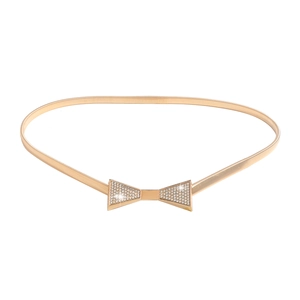 Elegant gold metal stretch belt for women with rhinestone bow buckle on white background