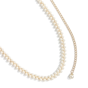 Close-up of elegant double-row pearl waist chain with golden alloy metal linkage