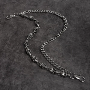 Detail of silver skull pants chain with layered metal links and punk style lobster clasps