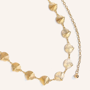 Golden metal waist chain with textured shell pendants and a polished ball charm