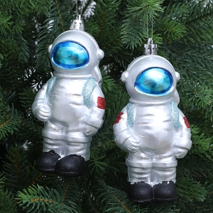 Space themed astronaut Christmas ornaments set with silver finish on pine branch