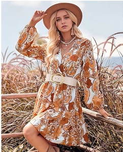 Close-up of bohemian floral dress with an irregular elastic waist belt and puff sleeves