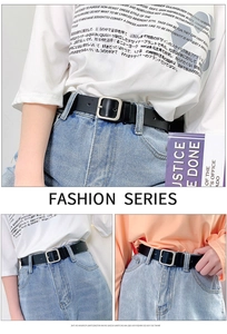 Close-up of black leather belt with silver square buckle styled on blue denim jeans