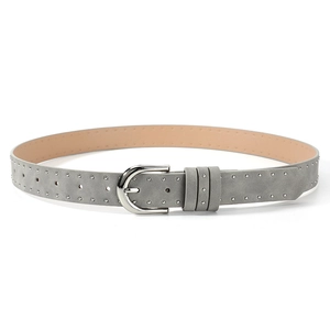 Detail of light gray suede belt with silver metal studs and horseshoe buckle closure