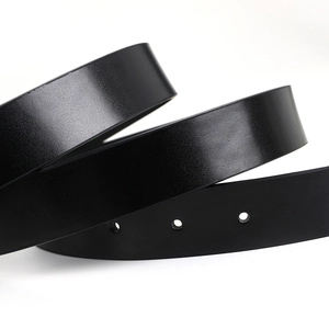 Detailed close-up of premium black leather belt texture with double O-ring buckle holes
